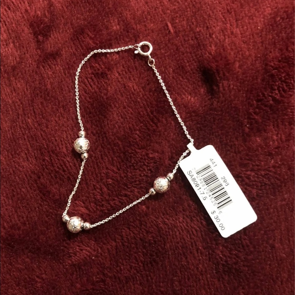 NWT sterling silver bracelet with ball like stationary attachments.